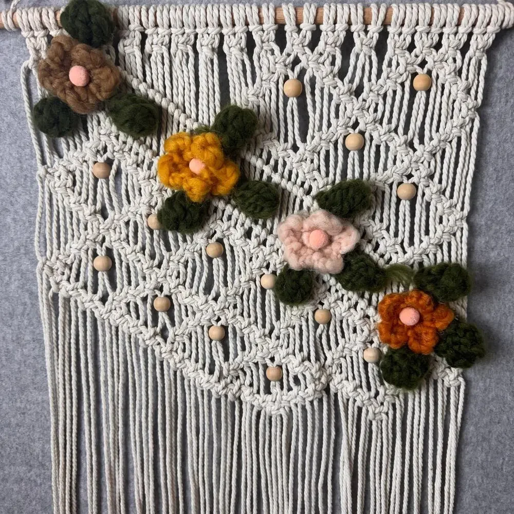 handmade boho-style macramé wall hanging crocheted flowers wooden beads fringe